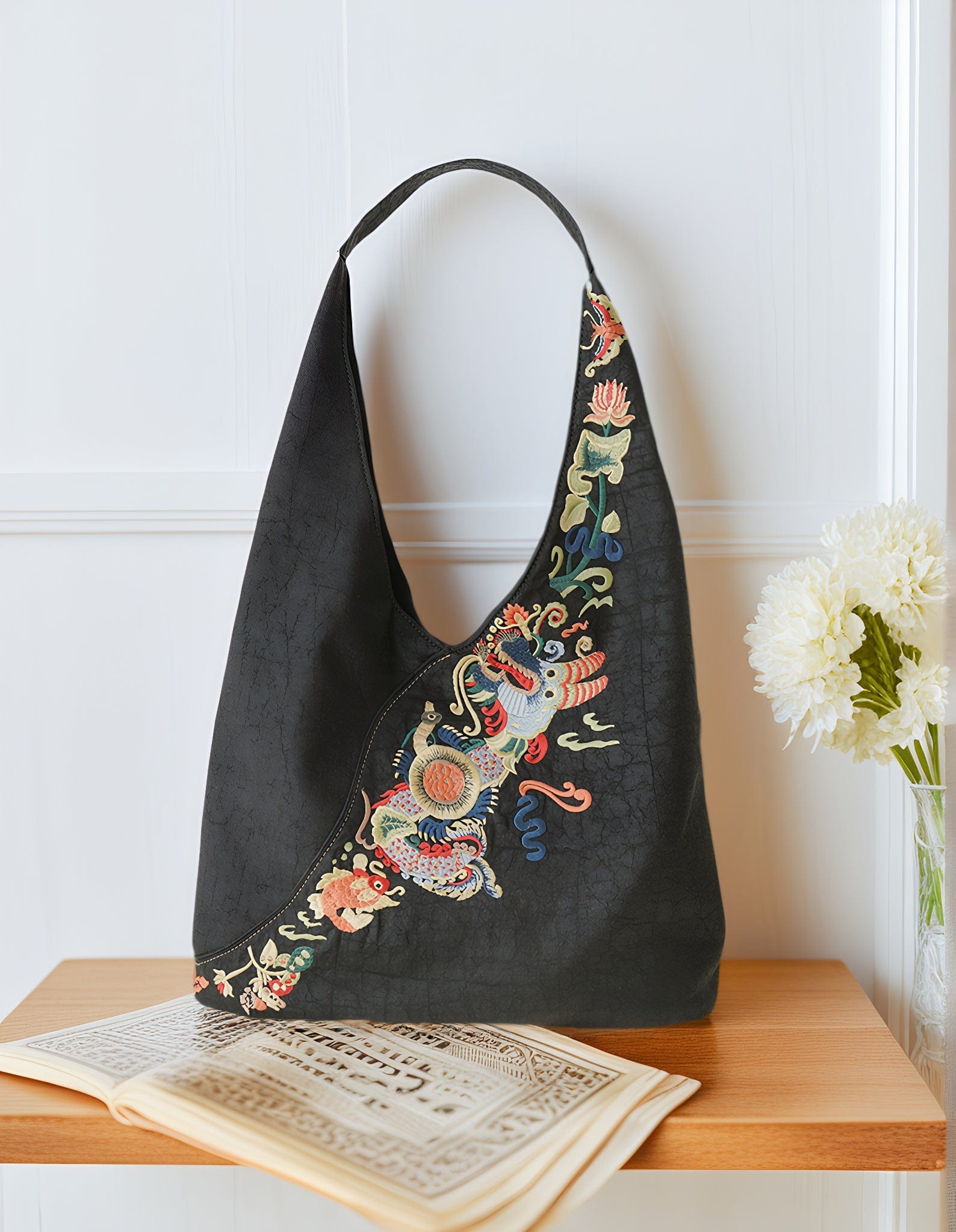 Front view of the Loong Li Xiangyunsha shoulder bag, showcasing its deep, naturally unique Xiangyunsha texture and the luxurious, exquisite hand-embroidered "Carp Leaping Over the Dragon Gate" motif.It shimmers with a charming luster under different lighting conditions.