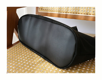 Detailed view of the bottom of the Loong Li tote bag, highlighting the structured base, reinforced stitching, and the unique texture of the Xiangyunsha fabric from below.