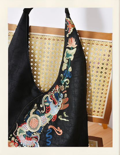 Luxury hand-embroidered 'Carp Leaping Loong Gate' pattern on the Loong Li Xiangyunsha shoulder bag, a symbol of success and good fortune in New Chinese style.