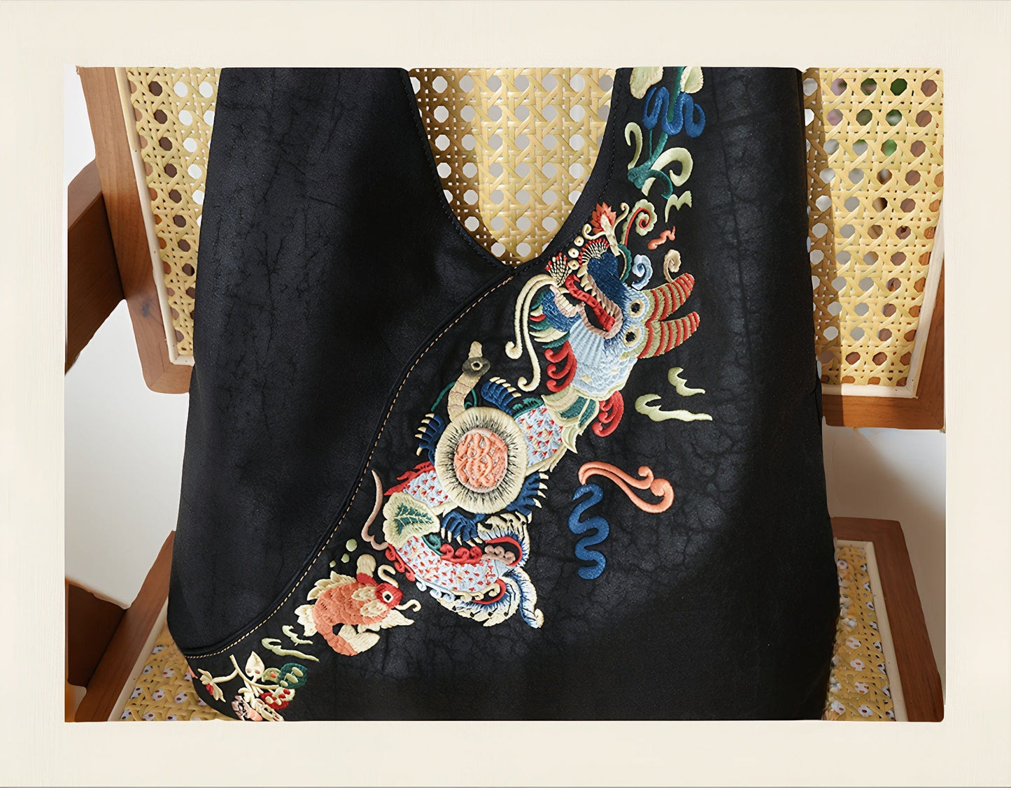 Luxury hand-embroidered 'Carp Leaping Loong Gate' pattern on the Loong Li Xiangyunsha shoulder bag, a symbol of success and good fortune in New Chinese style.