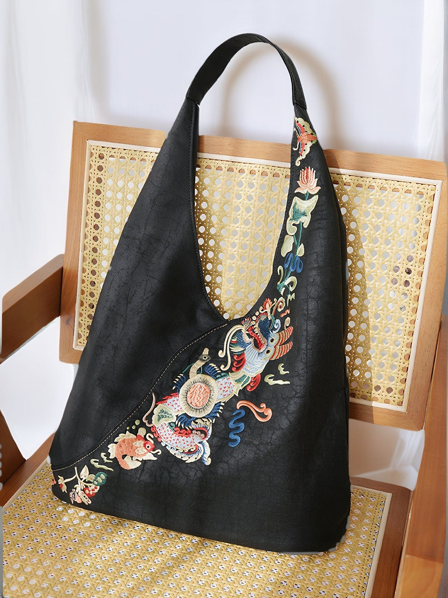 Front view of the Loong Li Xiangyunsha shoulder bag, showcasing its deep, naturally unique Xiangyunsha texture and the ​luxurious, exquisite hand-embroidered​ "Carp Leaping Over the Dragon Gate" motif.Adaptable to different  ​suitable for a wide range of scenarios.