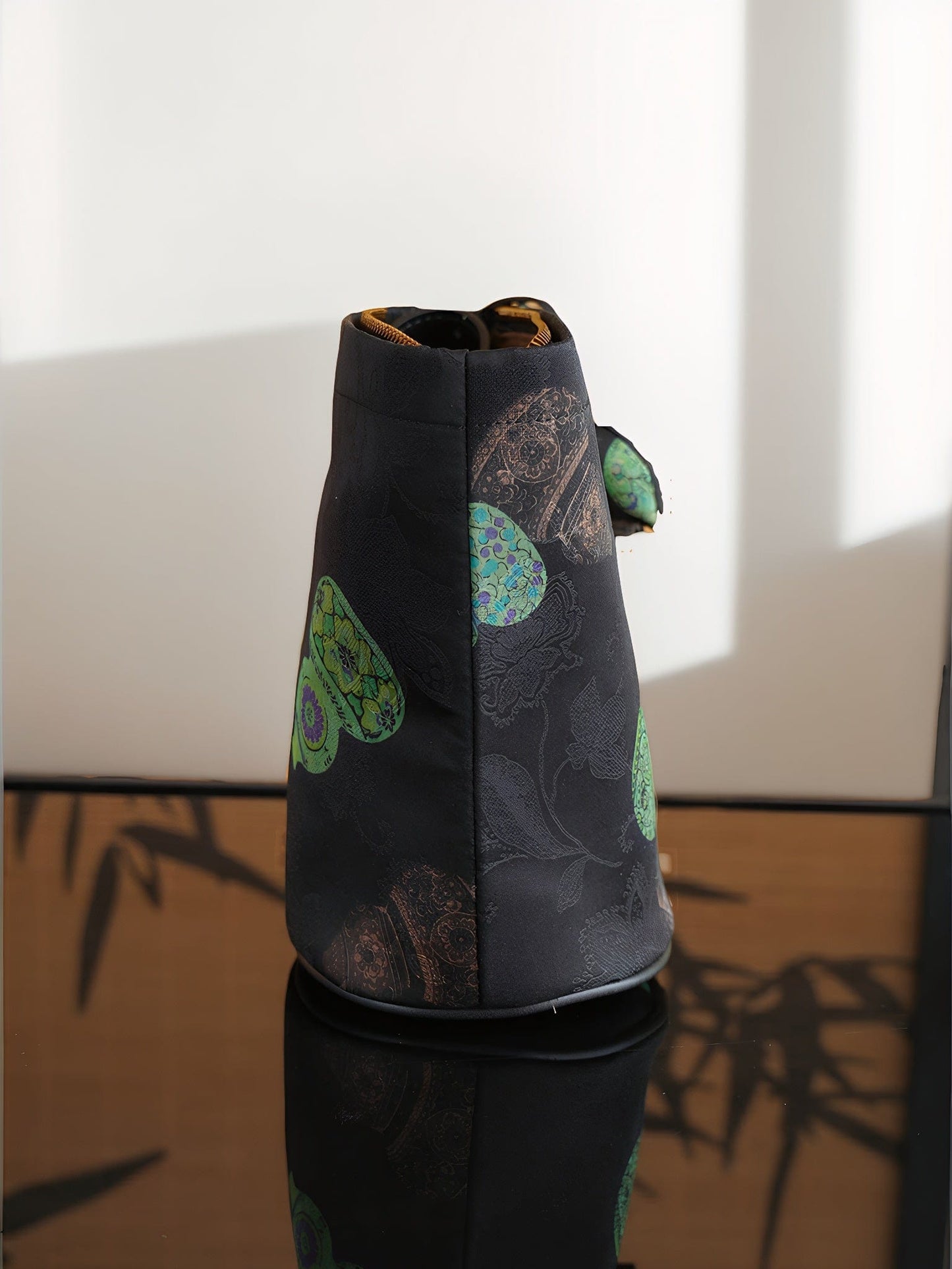 Side profile of the Lucky Gourd Xiangyunsha Silk Vintage Crossbody Bag, showcasing its ​structured silhouette​ that maintains a ​rigid upright form. The ​reinforced bottom​ prevents sagging, while the ​detachable gourd charm​ offers versatile styling for personalized wear.